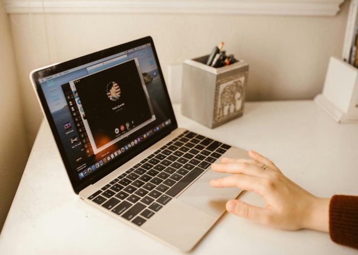 Close-up of a person making a video call on a laptop, showcasing modern communication technology.